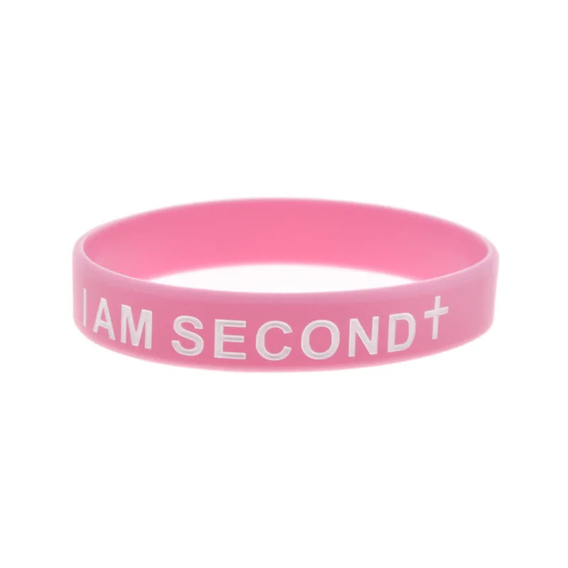 Pinkes Silikon-Armband mit dem Text "I AM SECOND" und einem Plus-Zeichen.