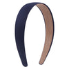 A pair of solid satin hair bands, one dark blue and one tan, shown in a curved shape.