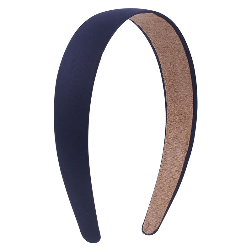 A pair of solid satin hair bands, one dark blue and one tan, shown in a curved shape.
