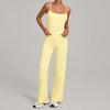 A woman wearing a yellow high-waist yoga and fitness tracksuit set.