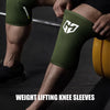 A close-up shot of a person wearing olive green compression knee sleeves during weight lifting.