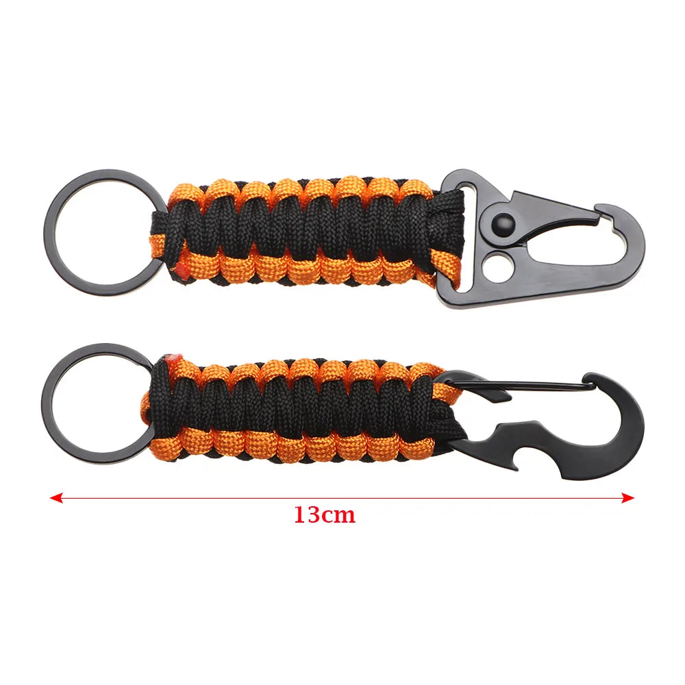 A multi-tool keychain featuring a black and orange braided cord and a metal clip.