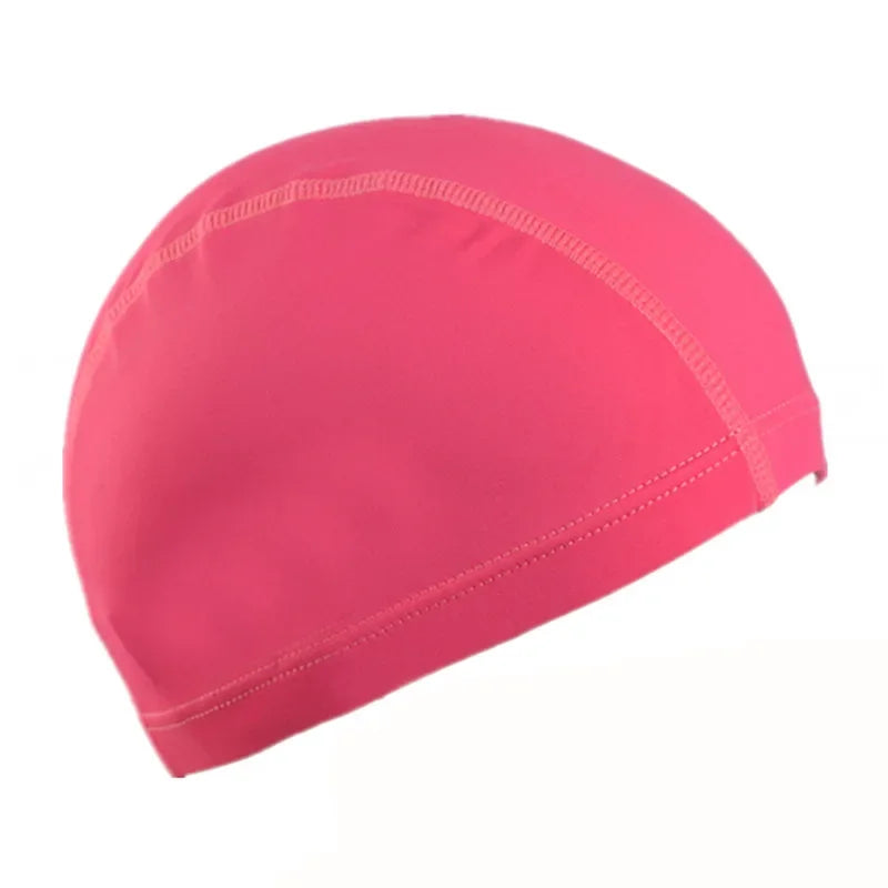 A bright pink ultra-thin nylon swimming cap shown from above.