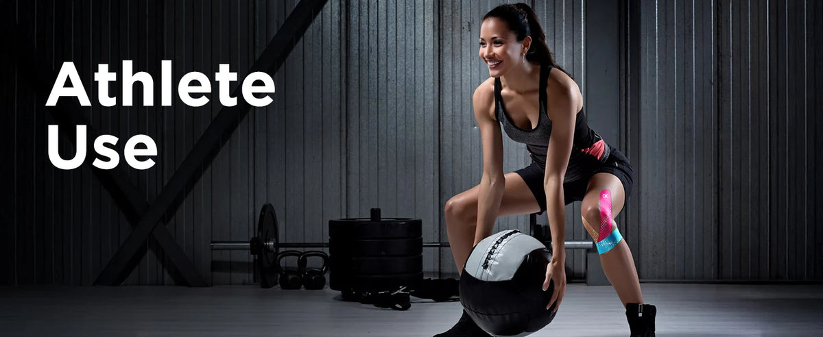 A woman in athletic wear is performing a workout exercise while holding a black exercise ball.