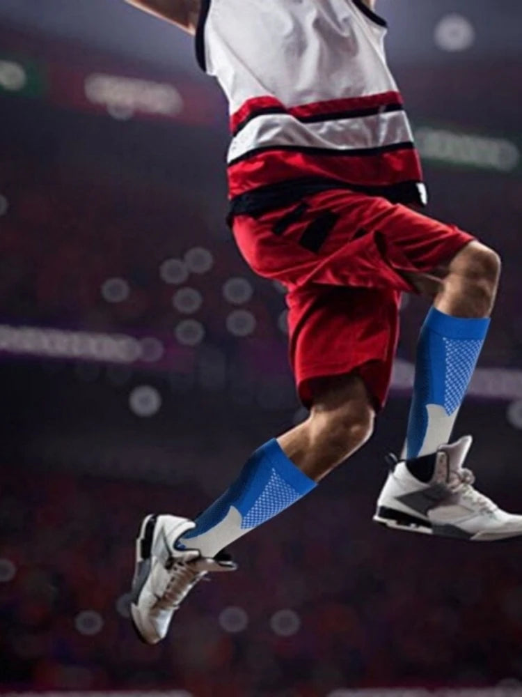 A person wearing a white and red sports uniform is mid-air, showing compression socks on their legs.