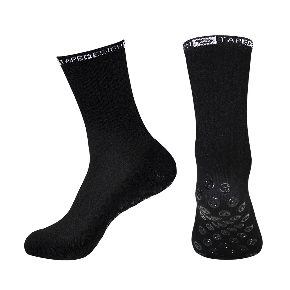 A pair of black performance sports gripping socks shown from the side.