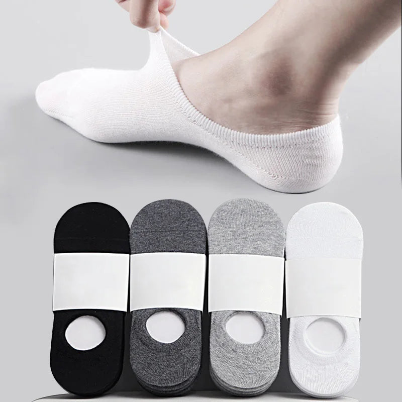 A set of men's invisible silicone no-show socks shown on a foot and laid out individually.