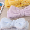 A set of soft, fuzzy microfiber spa headbands and wristbands in lavender and light blue colors.