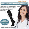 A woman wearing a white coat smiles while holding an upgraded compression sock and a stethoscope.