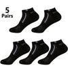 Five pairs of black mesh ankle socks displayed on a white background.