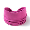 A magenta fabric hair wrap or headband for women, rolled and tied.