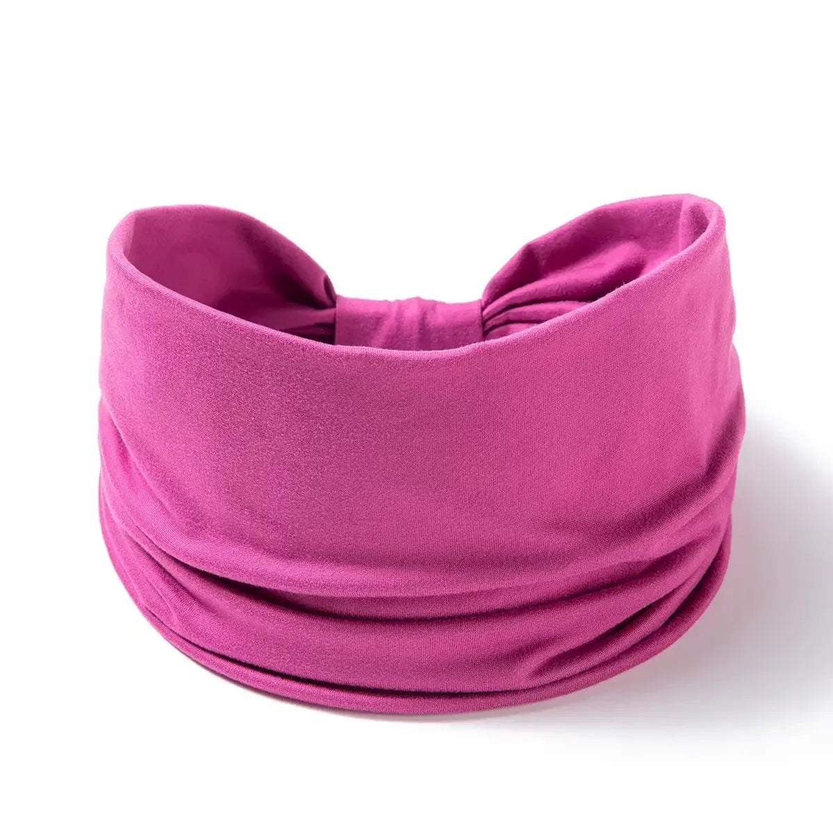 A magenta fabric hair wrap or headband for women, rolled and tied.