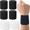 A hand is holding a black and white set of multi-sport breathable wristbands for activewear.