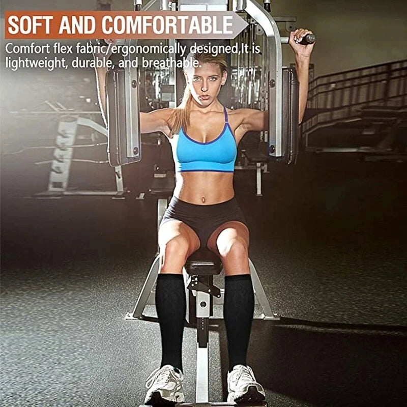 A woman wearing blue sports bra and black shorts is demonstrating high-compression knee-high stockings.