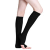 A pair of black medical grade compression socks worn on a person's legs.