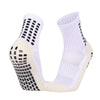 A pair of white and beige performance sports grip socks shown from the side.