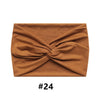 A brown fabric headband tied in a knot, shown flat lay.
