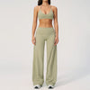 A woman wearing a light olive green women's premium fitness tracksuit top and matching high-waisted pants.