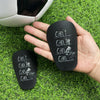 A hand holds a black silicone mini wear-resistant shin guard with the text Can't Can I Can