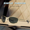 A pair of simple fashion sunglasses with a metal frame resting on a light-colored surface.