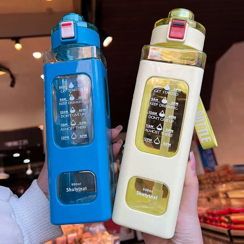 A hand holds a blue leakproof sport water bottle and a white bottle with a yellow cap.