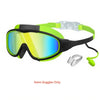 A pair of neon yellow-green swim goggles with a black frame and adjustable strap, along with nose clips and earplugs.