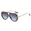 Vintage oversized designer black sunglasses with gold-toned arms and tortoiseshell lenses