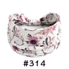 A floral patterned fabric headband tied in a bow, suitable for yoga or workout.