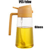 A 1 piece yellow glass oil sprayer with a handle is shown.