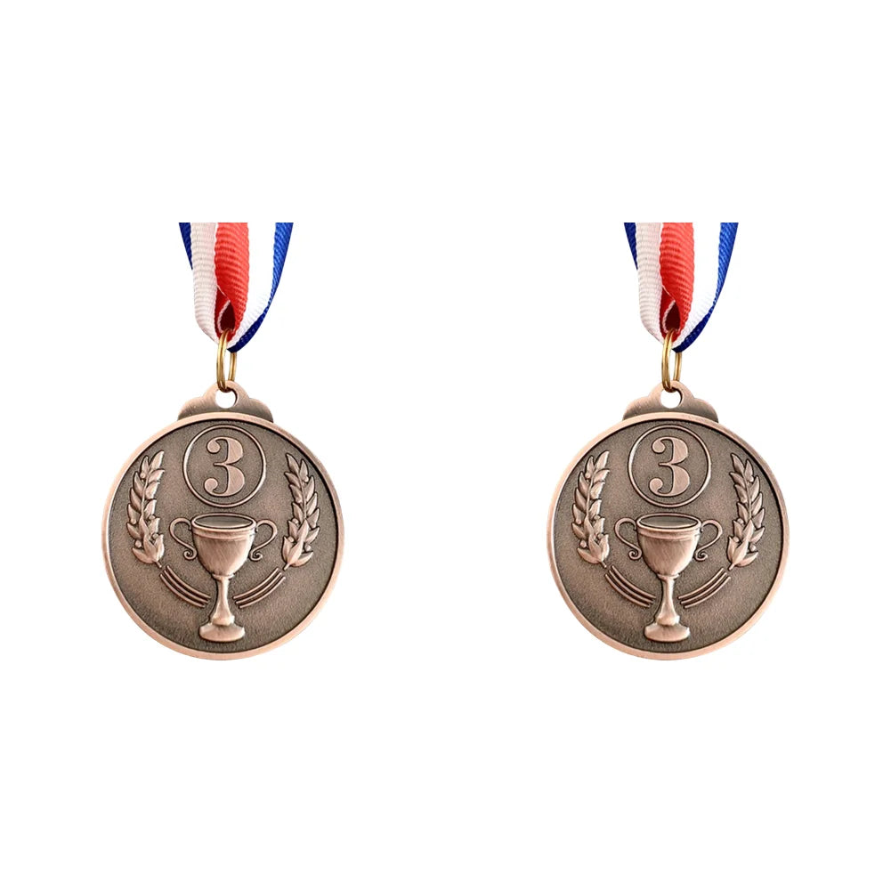 Two round bronze sports achievement medals with ribbons and a trophy design