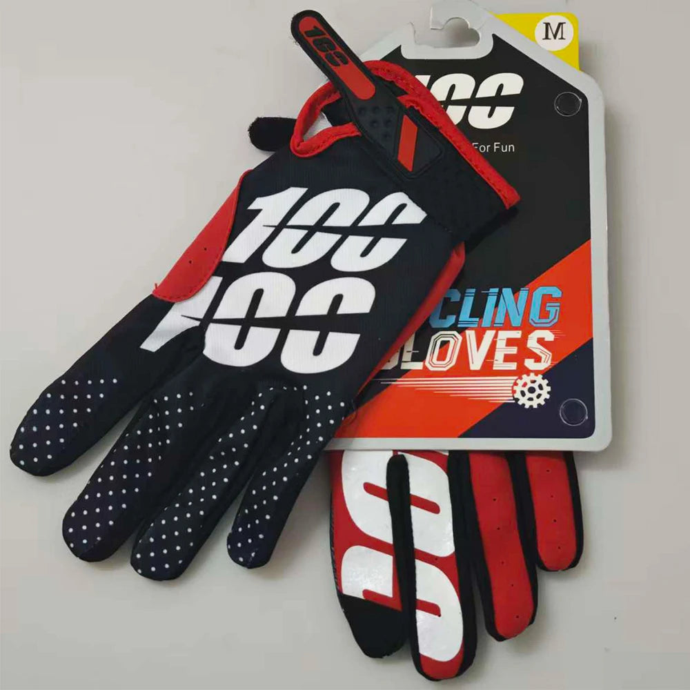 A pair of black and orange sports gloves for outdoor activities displayed next to their packaging.