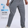 Gray Ice Silk high stretch pants worn by a man, featuring a drawstring waist and side pockets.