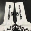 Pair of white football socks with black grip dots