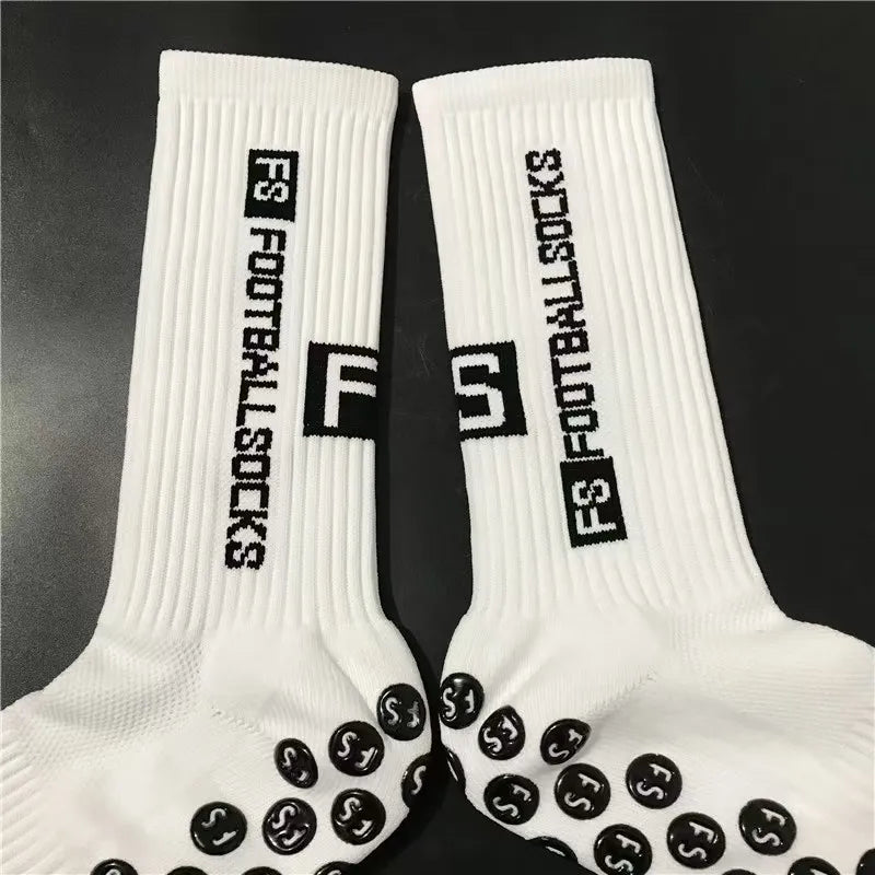 Pair of white football socks with black grip dots
