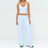 A woman wearing a light blue women's premium fitness tracksuit top and matching pants.