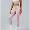 A woman wearing light pink high-waist yoga leggings and a matching sports bra top.