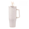 A white insulated thermos mug with a light pink lid and a textured body.