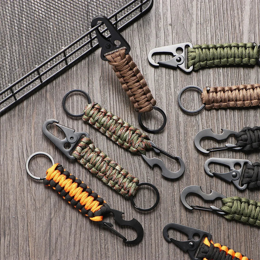 A collection of multi-tool keychains featuring various colored cord wraps and metal clasps.