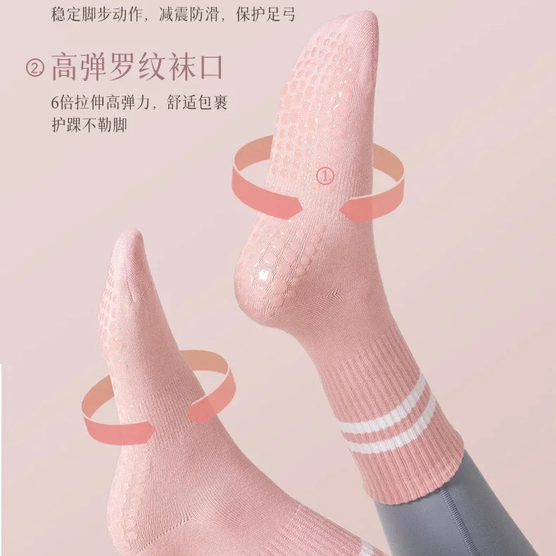 A close-up of pink non-slip yoga socks being worn on a foot, highlighting the textured material and design features.