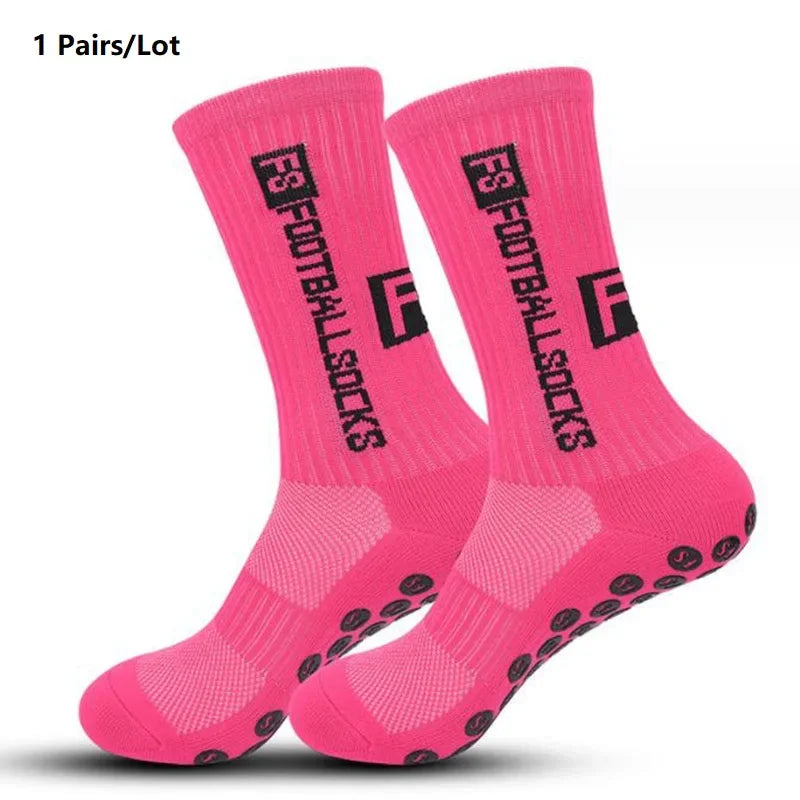 A pair of bright pink anti-slip performance sports socks shown flat.