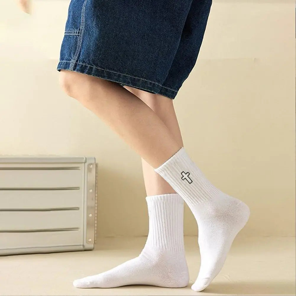 A close-up of white men's high-cut breathable casual crew socks worn on a person's foot.
