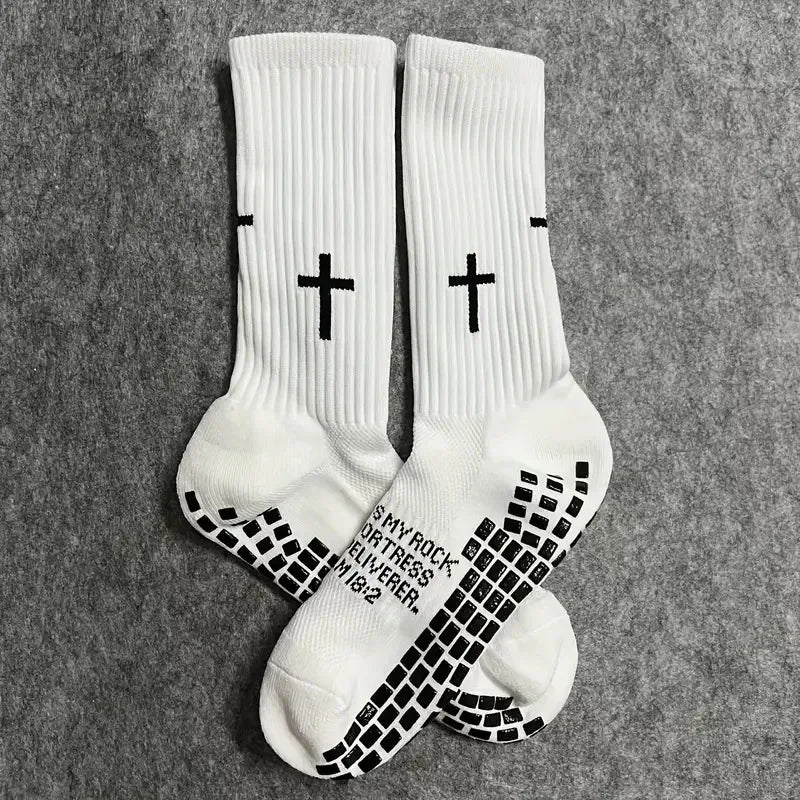 White athletic socks with black cross patterns on the toes and heel.