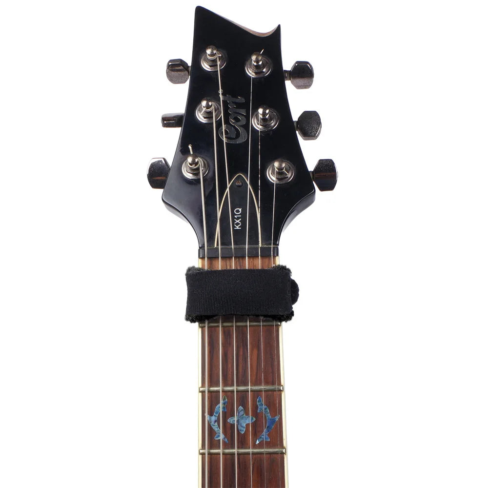 A close-up view of a black electric guitar neck showing the tuning pegs and fretboard.