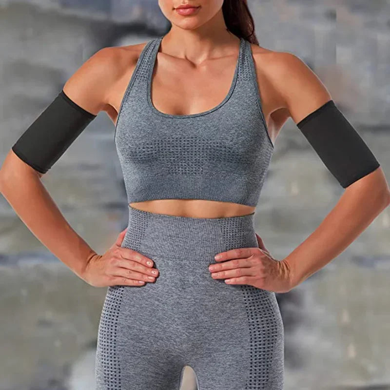 A woman wearing gray arm slimming compression bands for workout, showing the full body fit.