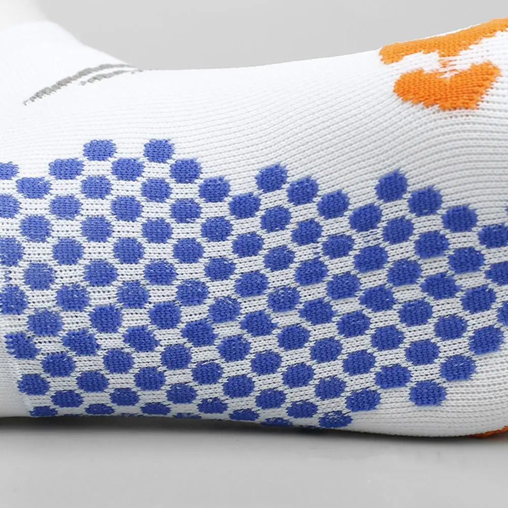 White cycling and running socks featuring a pattern of blue polka dots and orange accents.