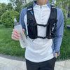 A person holds a clear silicone water bottle for sports and hiking against a green outdoor background.