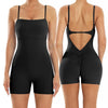 A woman models a black, backless fitness jumpsuit from the rear view.