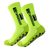 A pair of neon yellow performance sports socks with black text and grip dots.