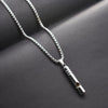 A silver stainless steel whistle pendant necklace for men displayed on a dark background.