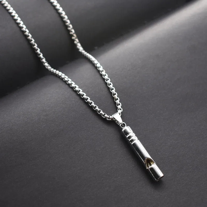 A silver stainless steel whistle pendant necklace for men displayed on a dark background.